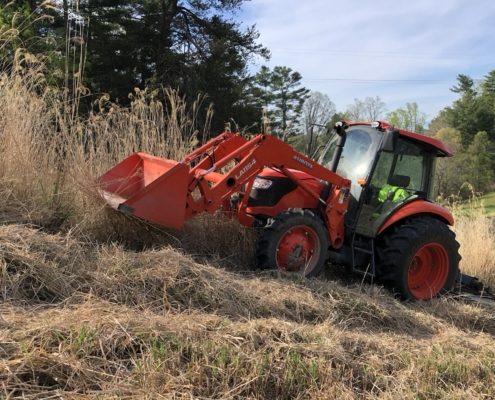 A machine performing bush hogging.