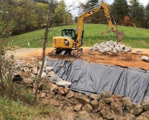 A machine performs work to control erosion.